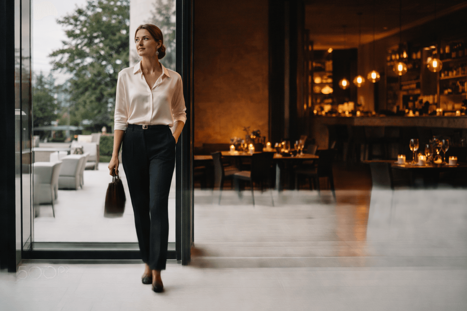 Model transitioning from office to evening with a silk blouse and leather accessories