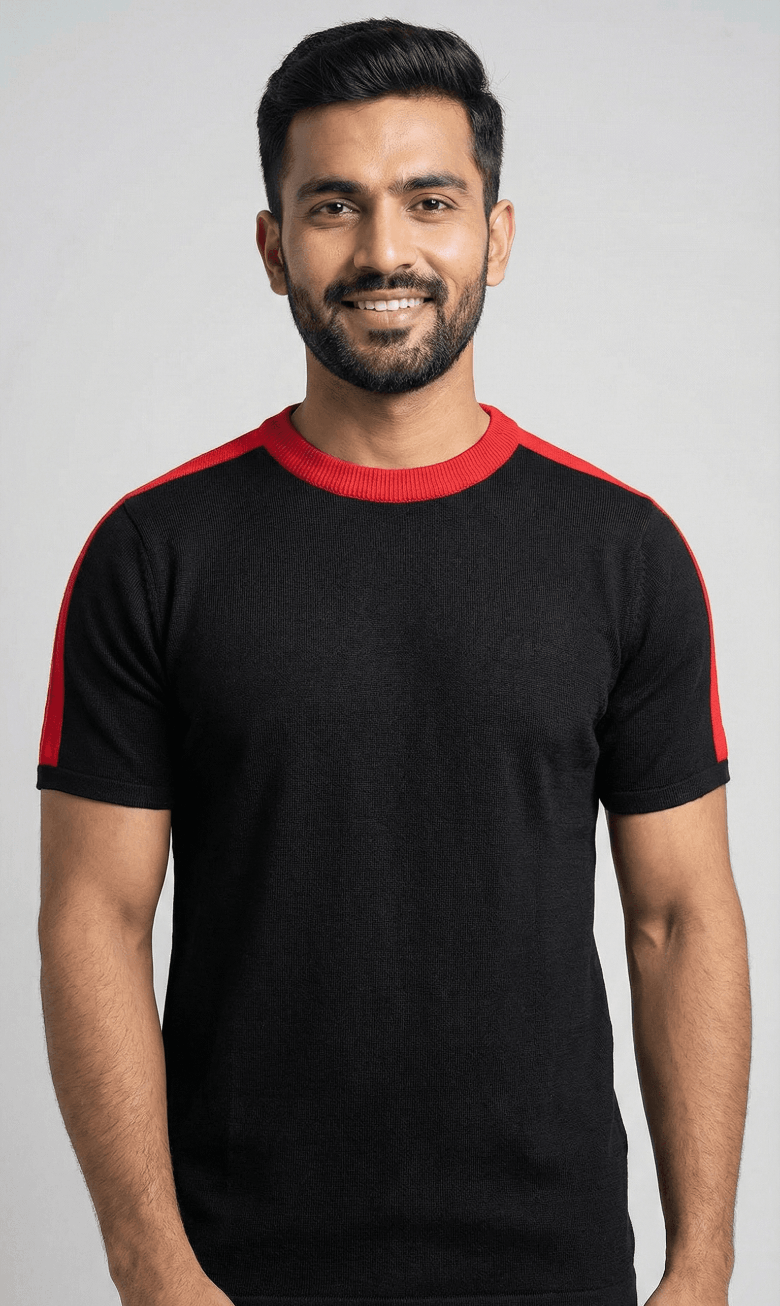 Man wearing black and red contrast knit tee - front view